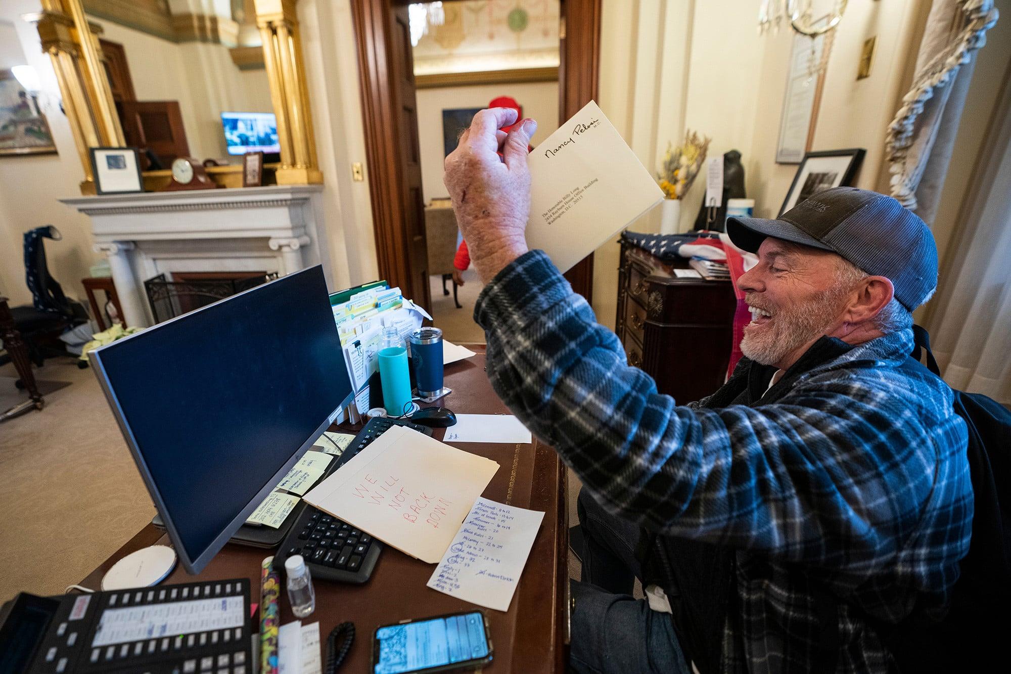 Barnett holding the envelope in question bearing Pelosi’s signature